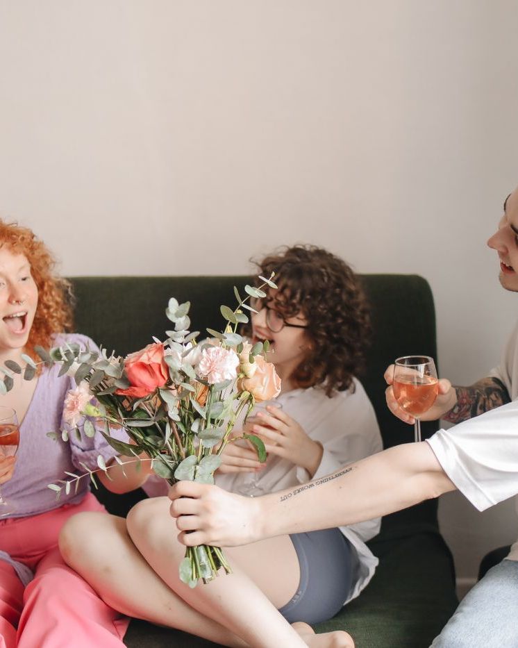 Friends laughing together on a sofa